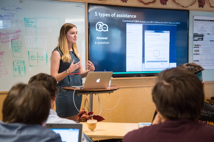 Graduate student Allie Fraser conducts a Q&A session before a panel during their dissertation proposal.